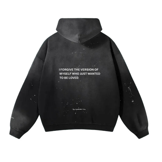 Black hoodie with text on the back against a teal background