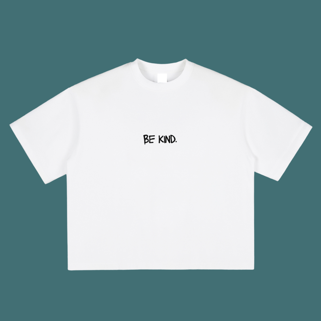 White t-shirt with 'BE KIND.' text on a teal background