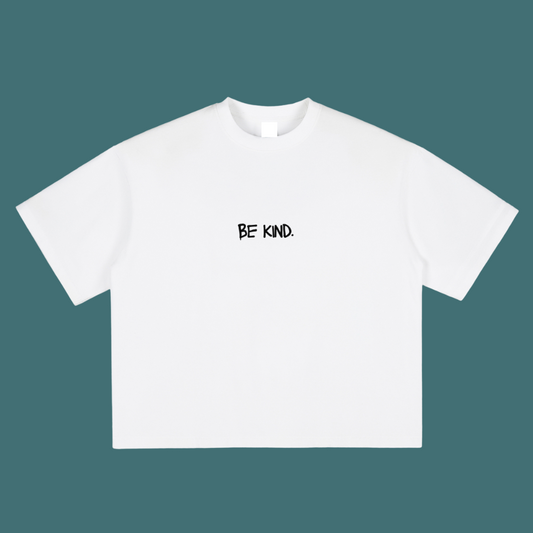 White t-shirt with 'BE KIND.' text on a teal background