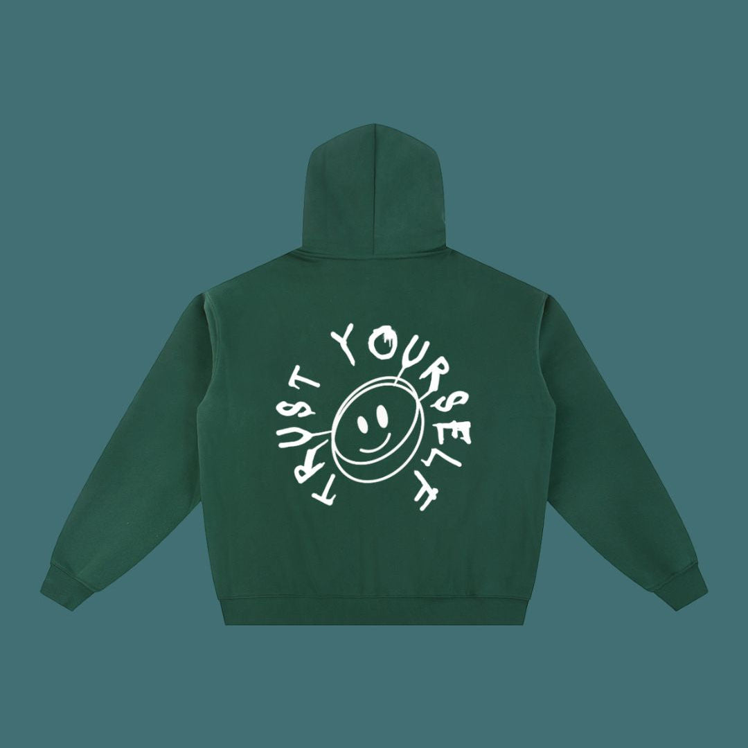 Green hoodie with 'Trust Yourself' text and smiley face on the back against a solid background