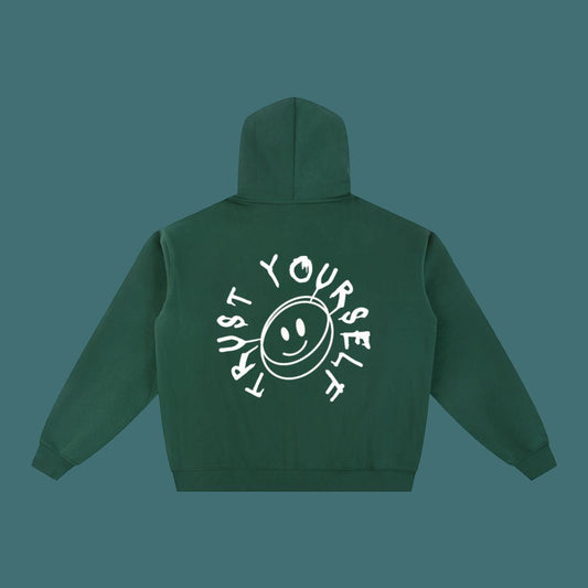 Green hoodie with 'Trust Yourself' text and smiley face on the back against a solid background