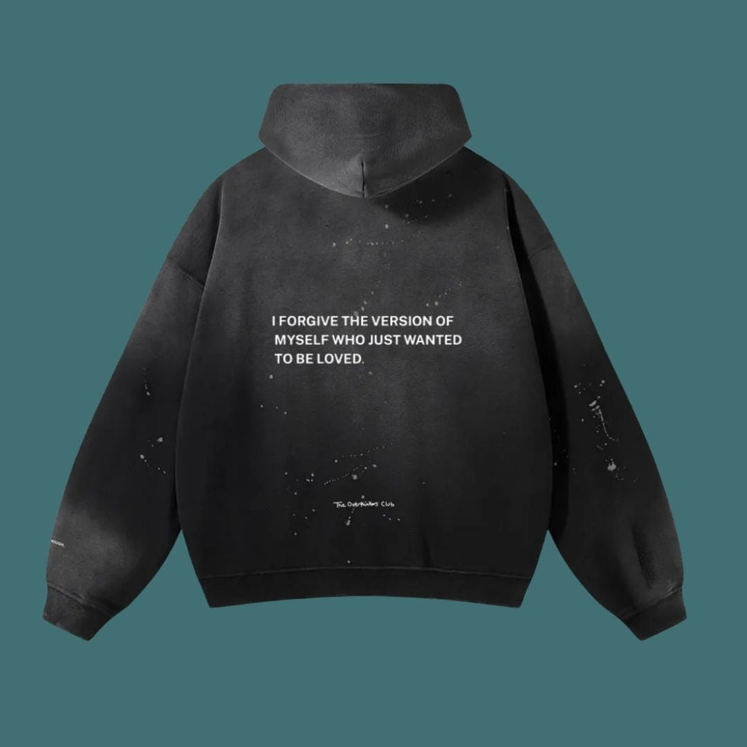 Black hoodie with text on the back against a teal background