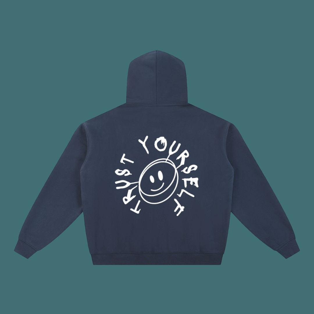 Navy blue hoodie with 'Trust Yourself' text and smiley face design on the back against a teal background