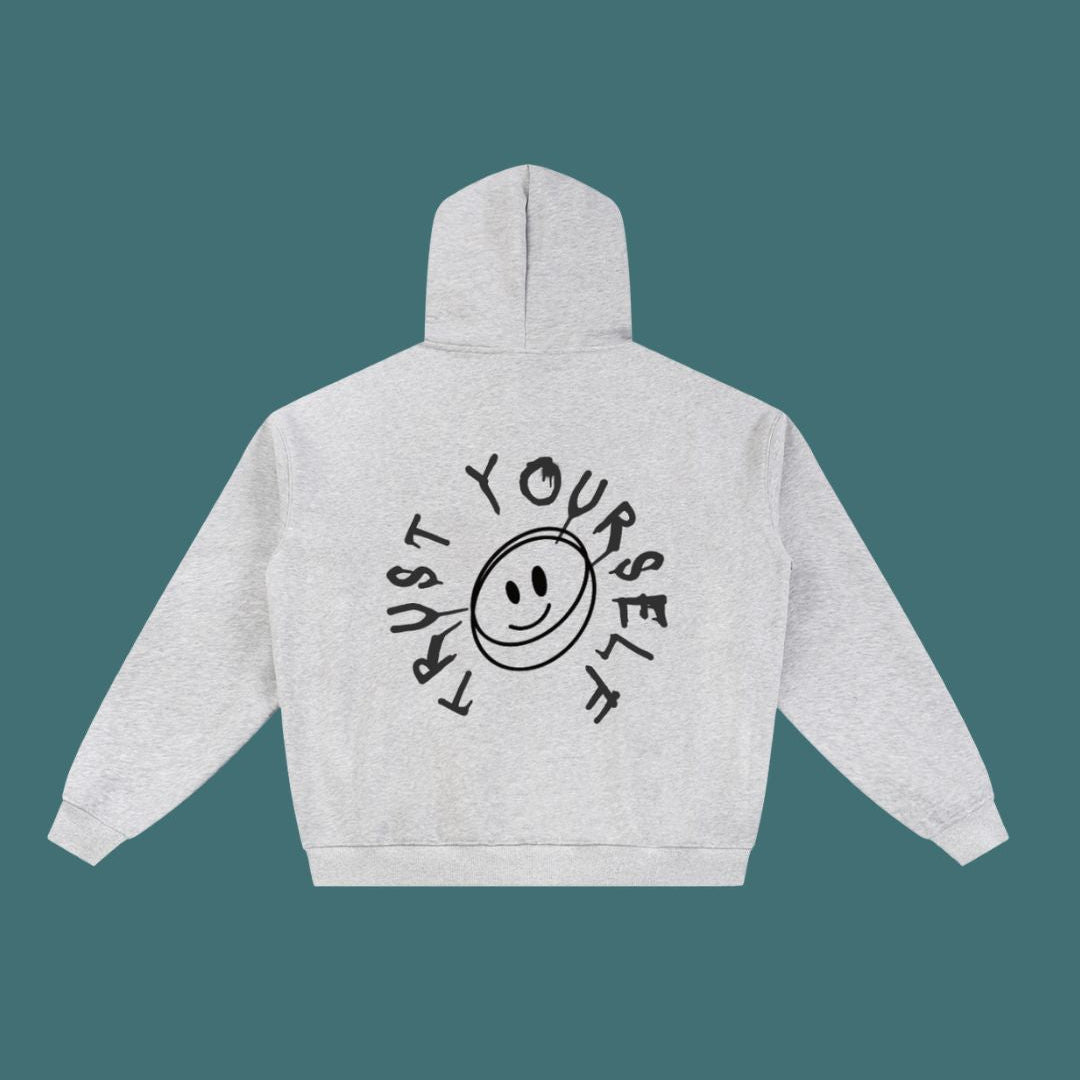 Gray hoodie with a smiley face and text on the back against a teal background