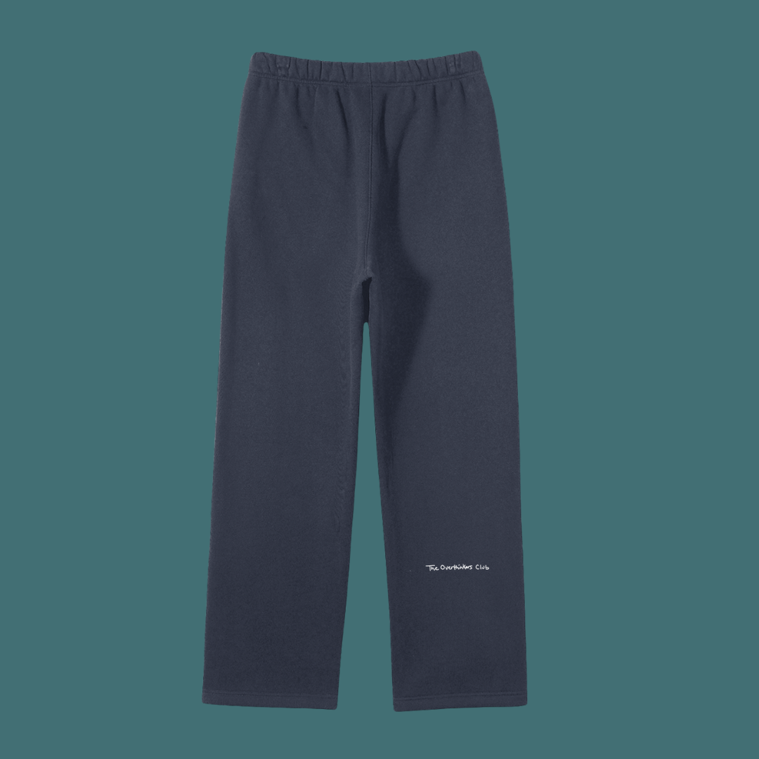 Navy blue pants with a brand logo on a dark green background