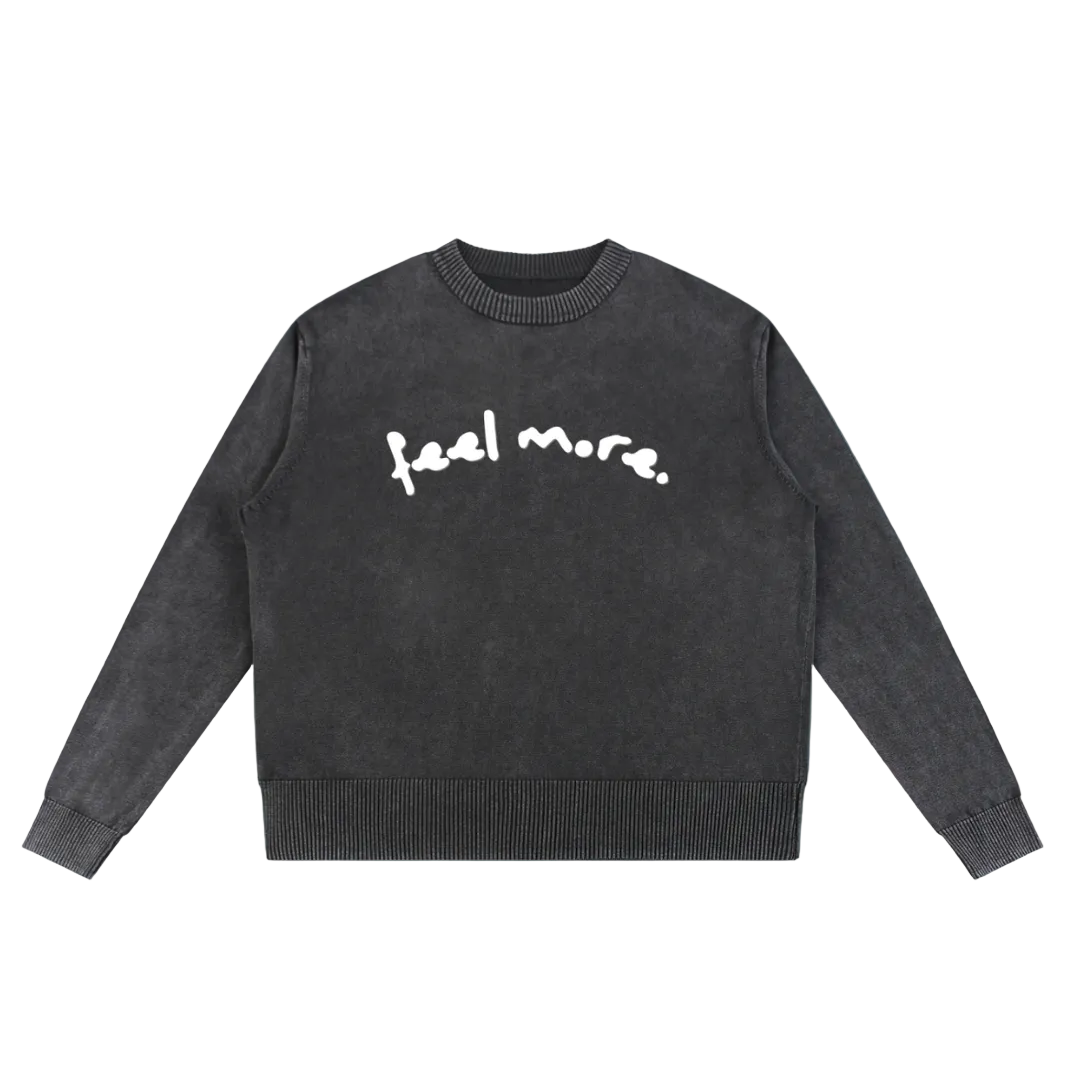 Dark gray sweater with 'feel more' text on a transparent background