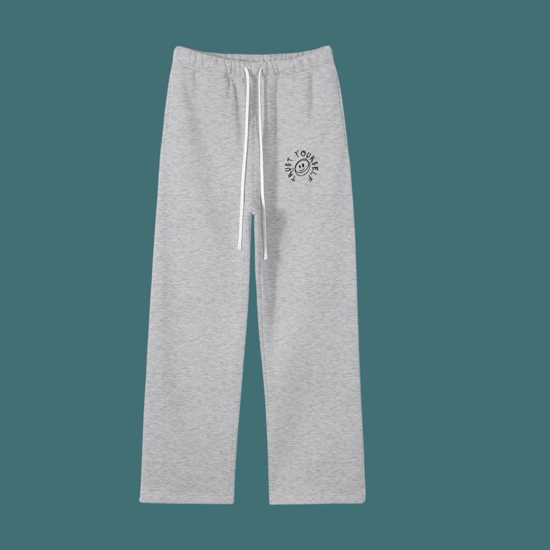 Gray sweatpants with a small logo on a teal background