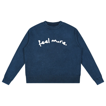 Navy blue sweater with 'feel more' text on a transparent background