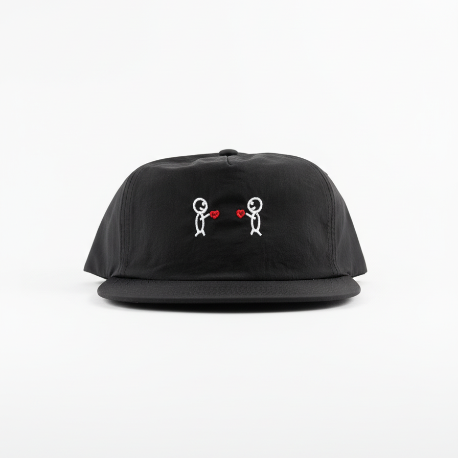 Black cap with embroidered designs on a white background