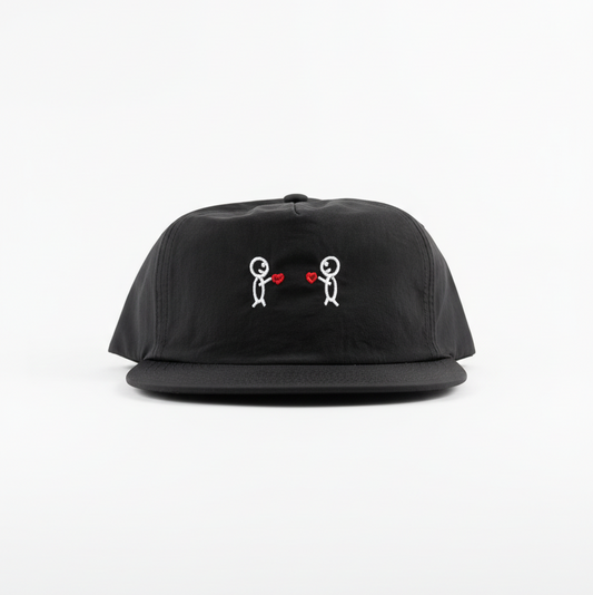 Black cap with embroidered designs on a white background