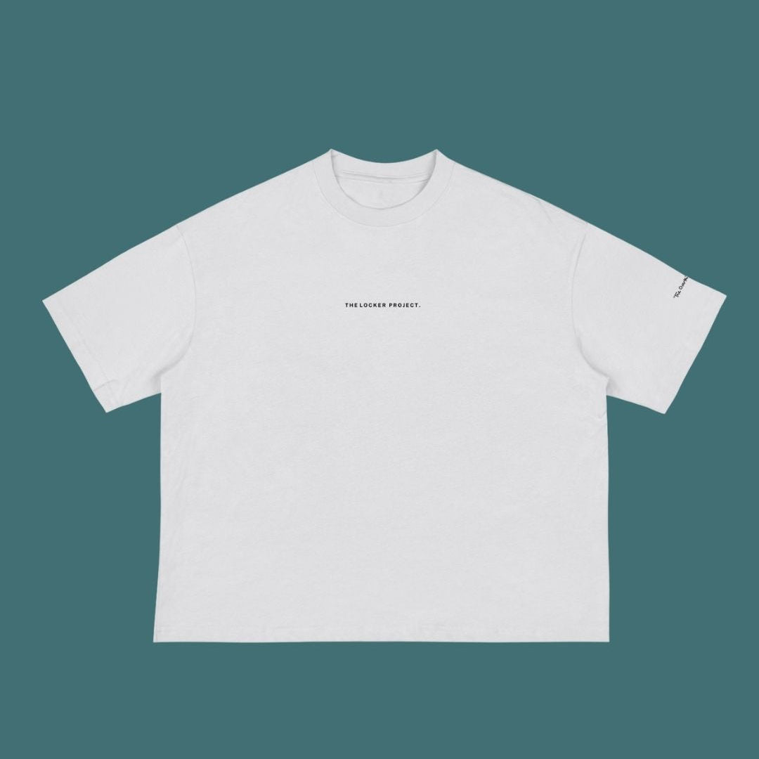 White t-shirt with text on a teal background