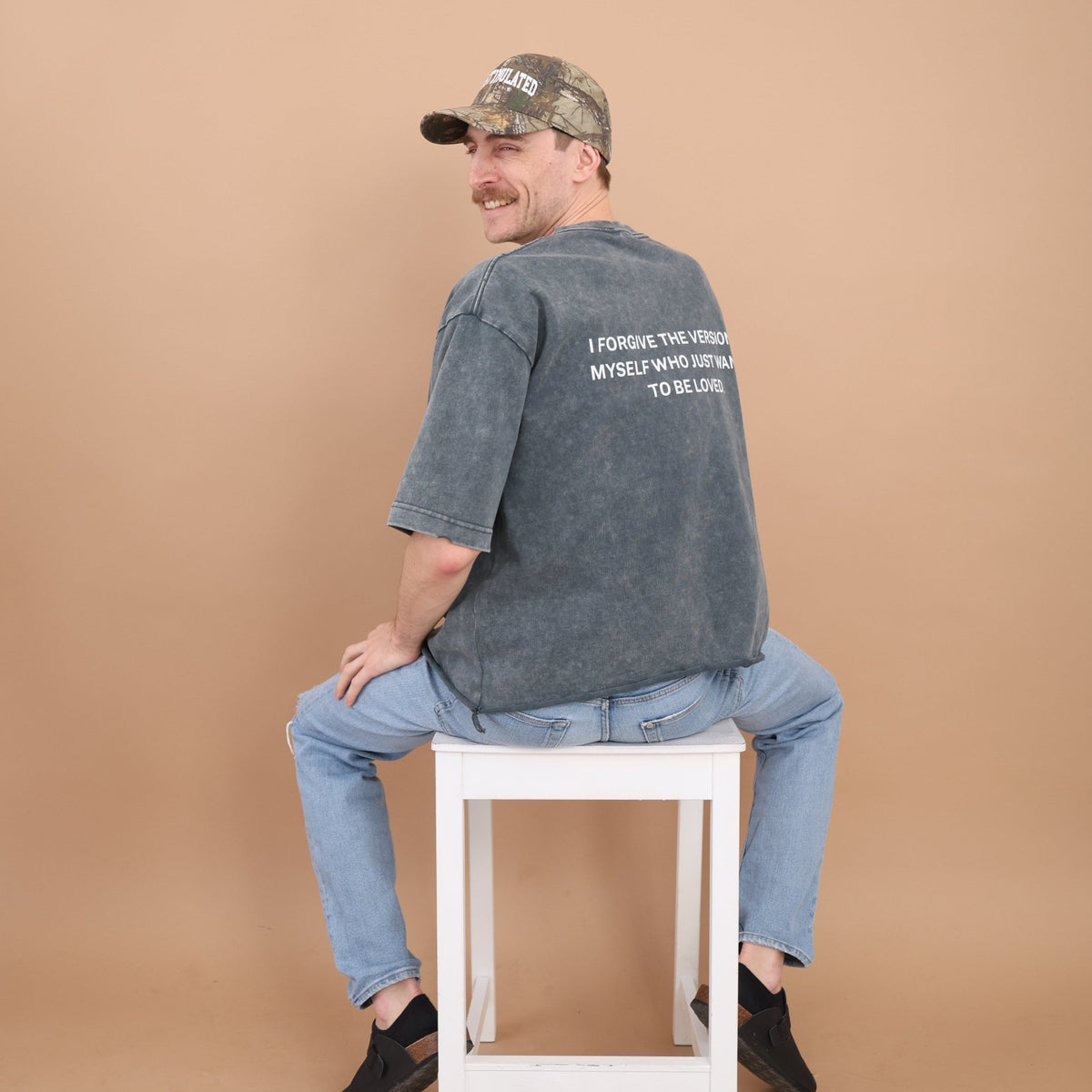 Forgiveness Vintage-Wash Tee — model lifestyle shot, washed grey front | Overthinkers Club